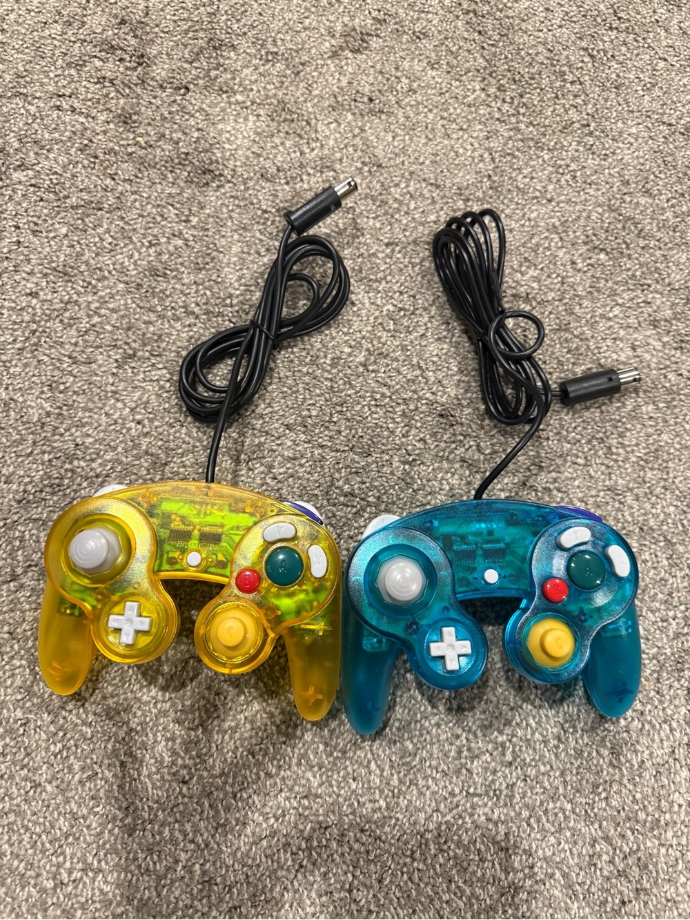 Yellow and Teal Wired game cube controllers